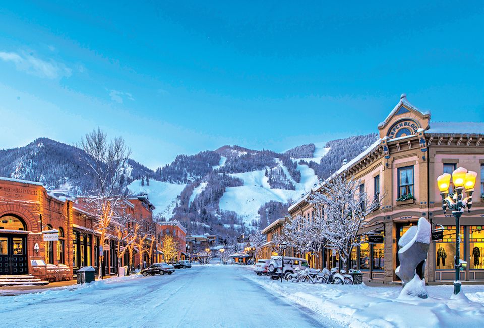 Snow-covered streets and mountain slopes in downtown Aspen.