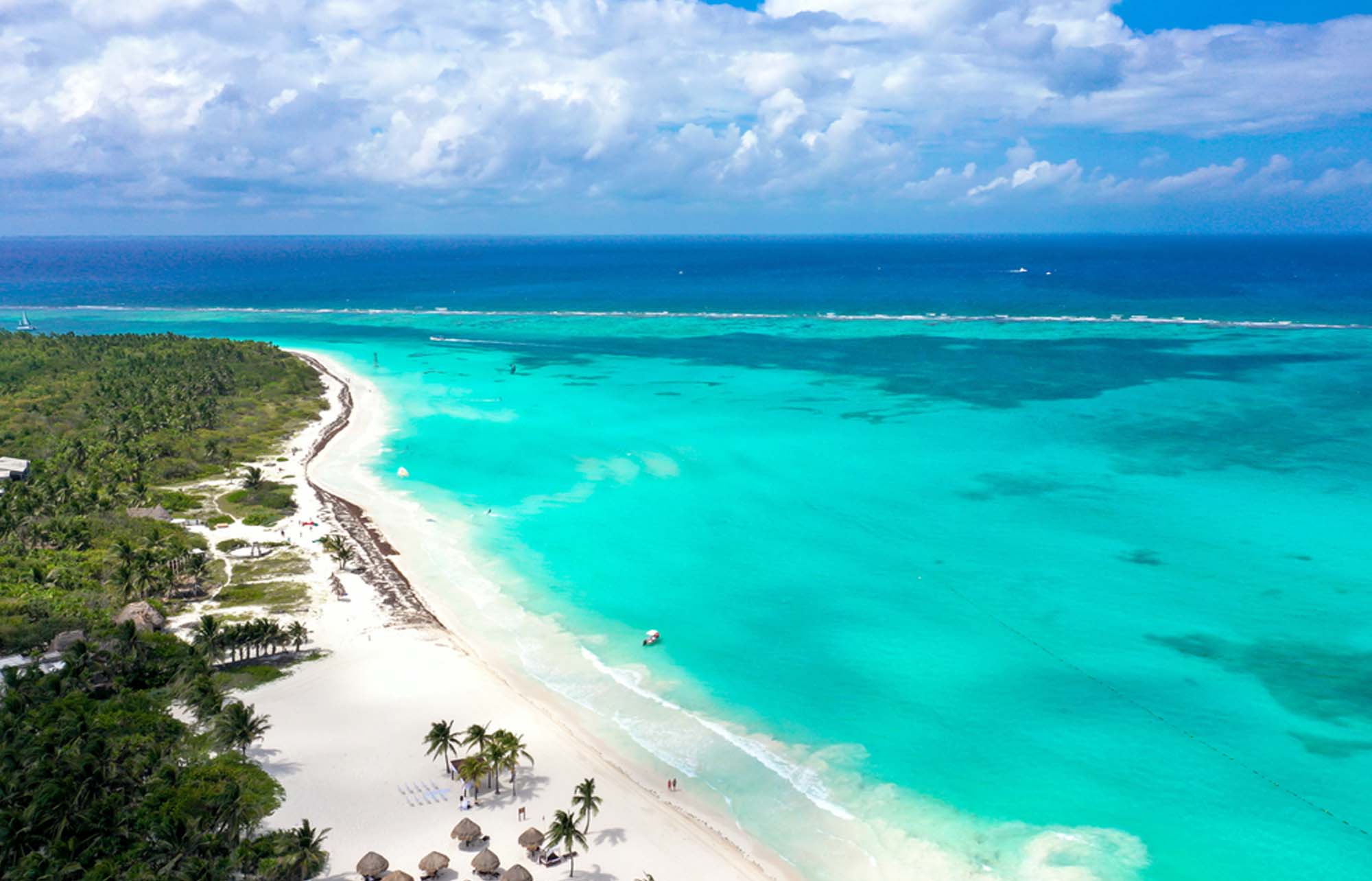 White sand and turquoise water along the Riviera Maya coast.